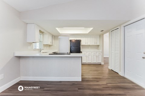 a white kitchen with white cabinets and a white counter top