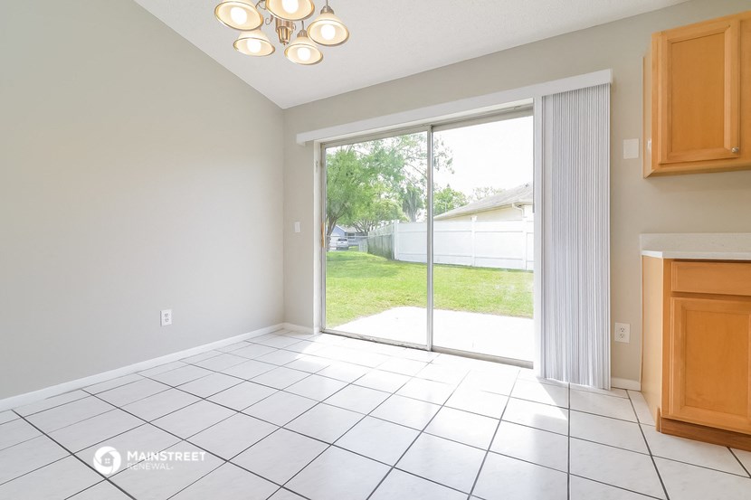an empty living room with a sliding glass door to the yard