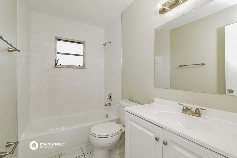 a bathroom with a sink toilet and a bath tub