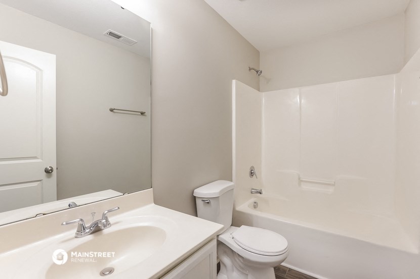 a bathroom with a sink and a toilet and a shower