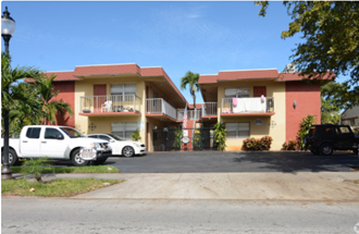 a street view of a building with cars parked in front of it