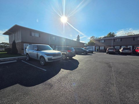 A white car is parked in a parking lot.