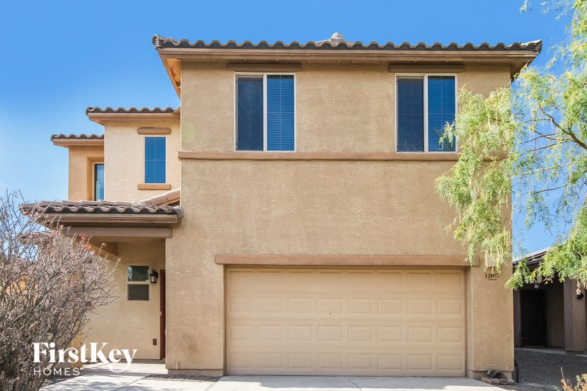a beige house with a garage door