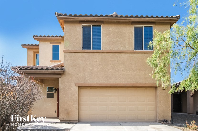 a house with a garage door in front of it