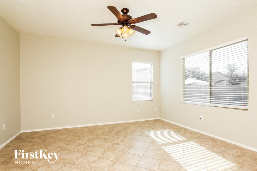a living room with a ceiling fan and a window