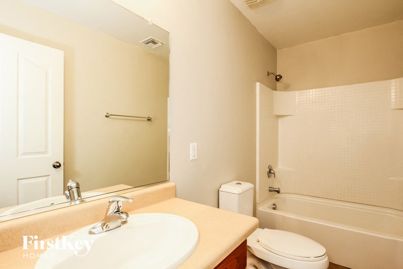 a bathroom with a sink and a toilet and a bath tub