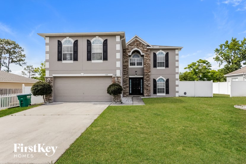 A house with a garage and a driveway is for sale.