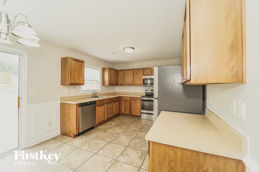 a kitchen with wooden cabinets and stainless steel appliances