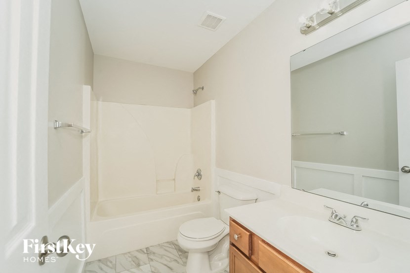 a bathroom with a sink toilet and a bath tub