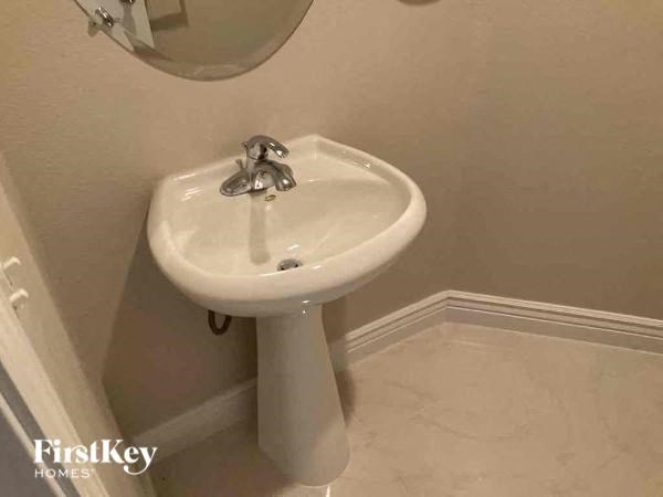 a bathroom with a white sink and a mirror