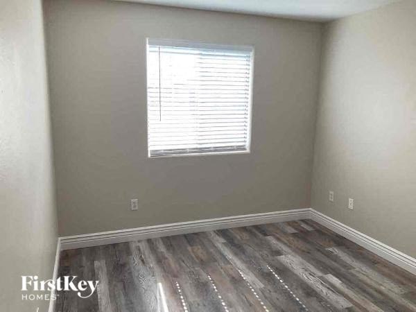 a empty room with wooden floors and a window