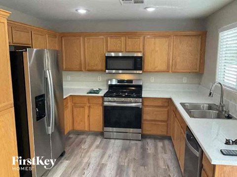 a kitchen with wooden cabinets and a stove and a refrigerator