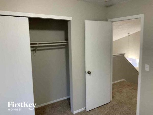 an empty closet in a room with a door open