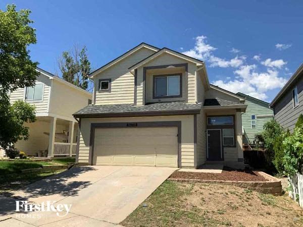a house with a garage door and a driveway