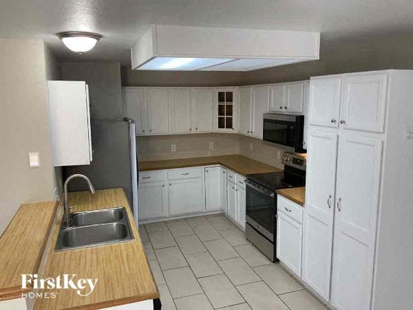 a kitchen with white cabinets and a sink