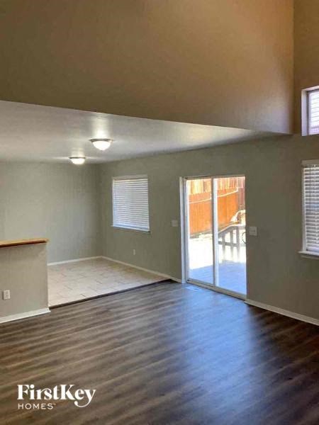 an empty living room with a door to a patio
