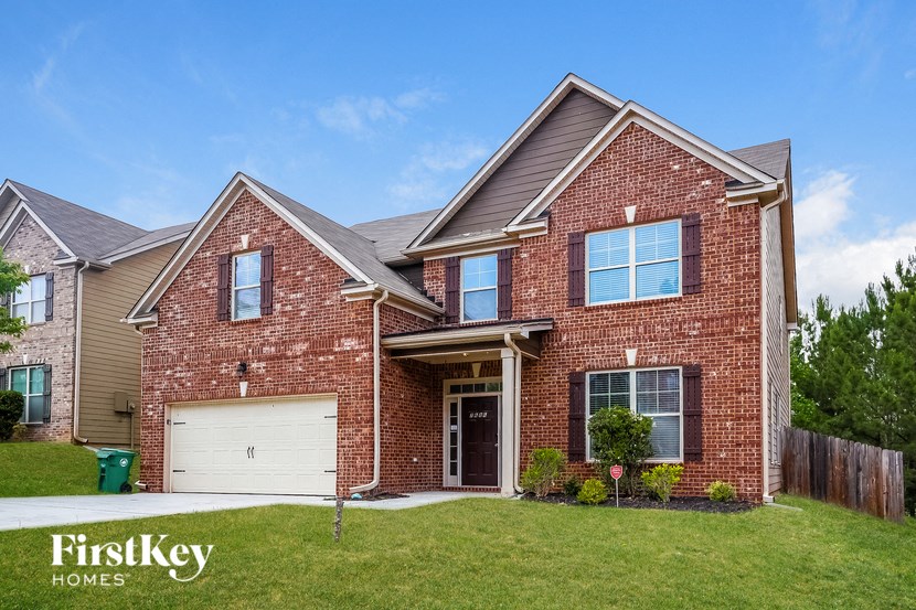 a red brick house with a white garage door
