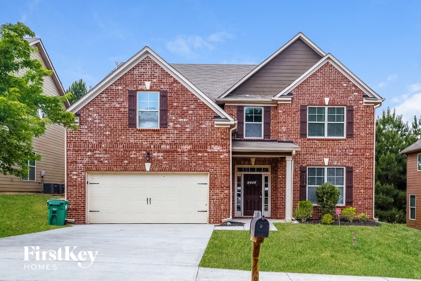 a red brick house with a white garage door