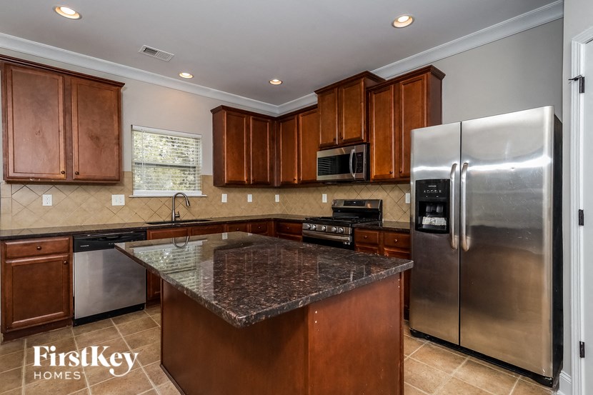 a kitchen with stainless steel appliances and granite counter tops