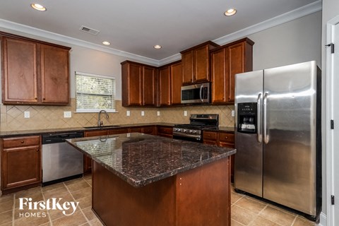 a kitchen with stainless steel appliances and granite counter tops