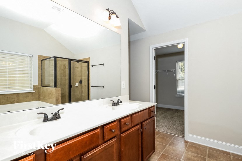 a bathroom with two sinks and a large mirror