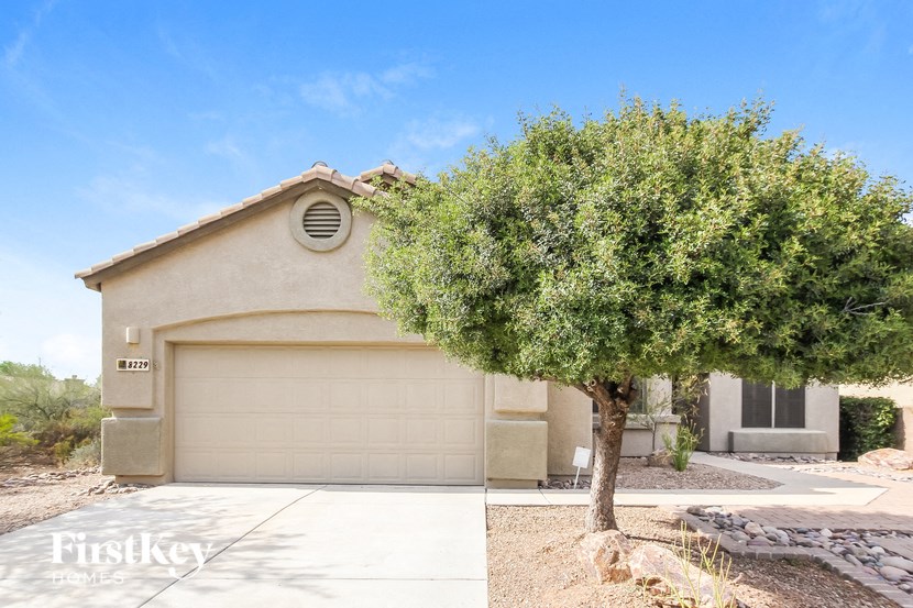 A house with a tree in front of it.