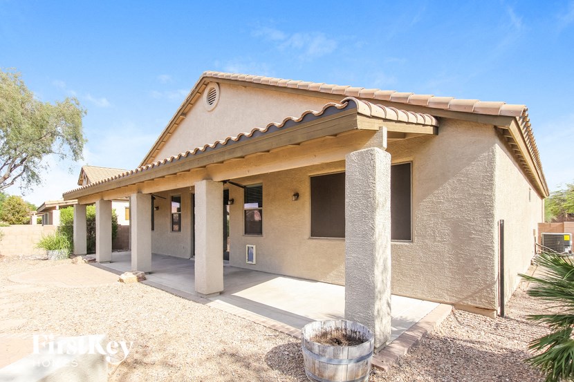 A house with a beige stucco exterior and a tiled roof.