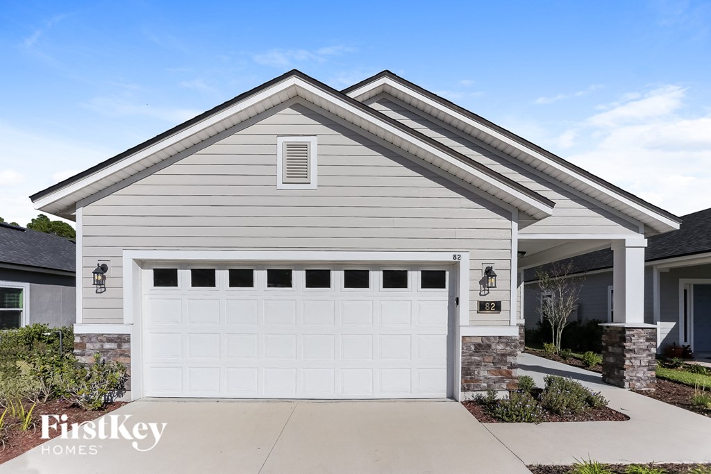 a white garage door in front of a house