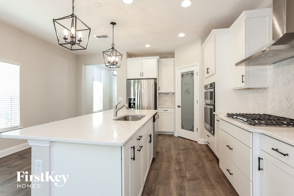 a white kitchen with white cabinets and a white counter top