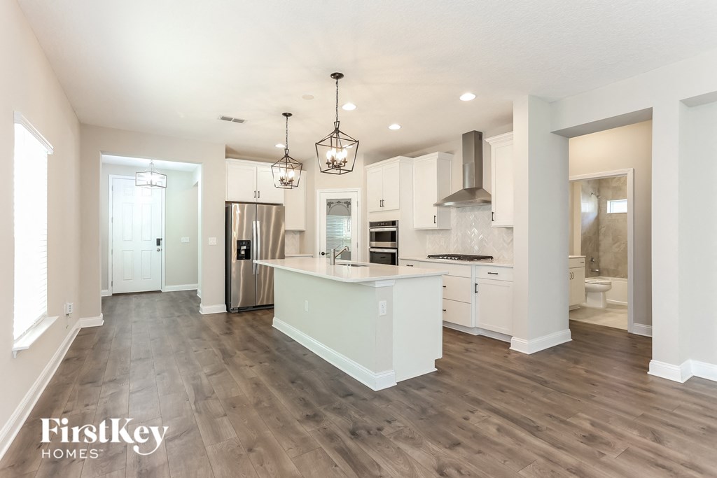 a renovated kitchen with white cabinets and a white counter top