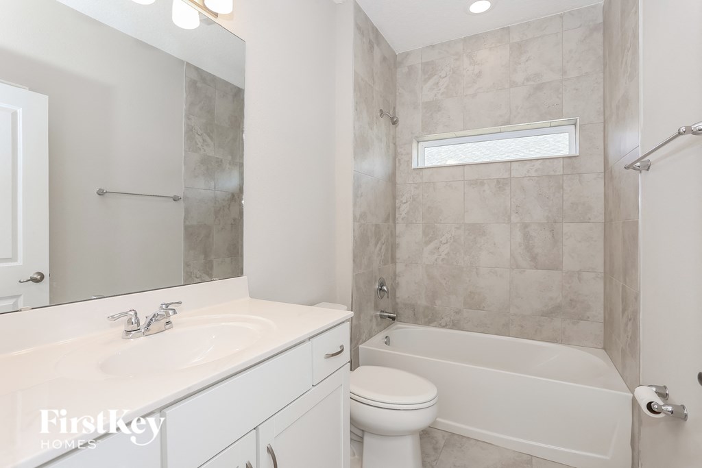 a bathroom with a sink toilet and a bath tub