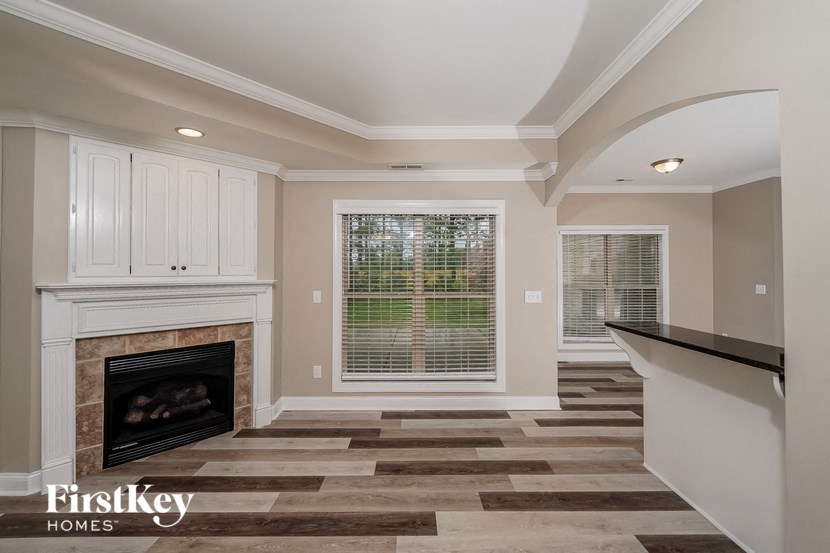a living room with a fireplace and a window