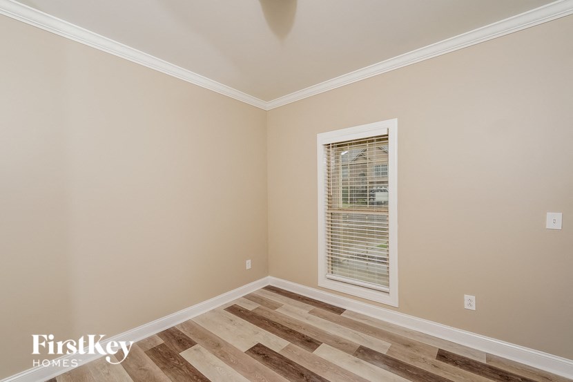 a living room with wood floors and a window