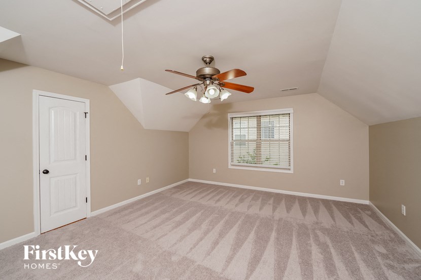 the master bedroom is spacious and has a ceiling fan