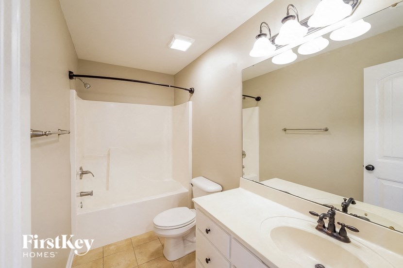 a bathroom with a sink and a toilet and a shower