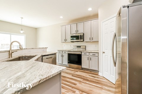 a kitchen with stainless steel appliances and white cabinets