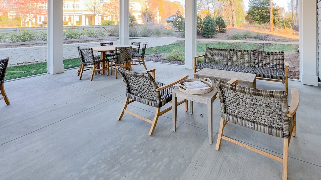 a patio with chairs and tables on a porch