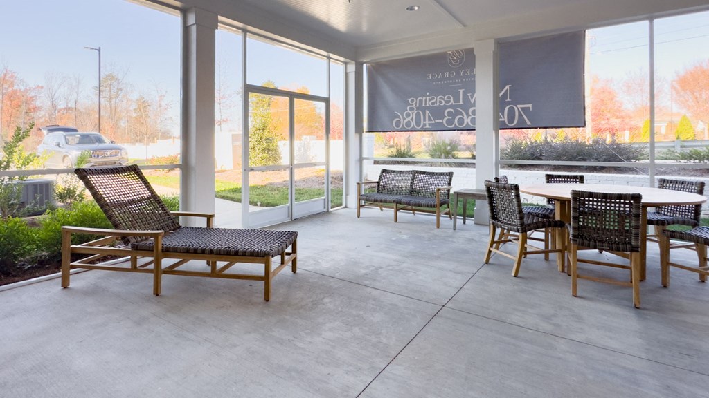 the lobby of a building with chairs and tables