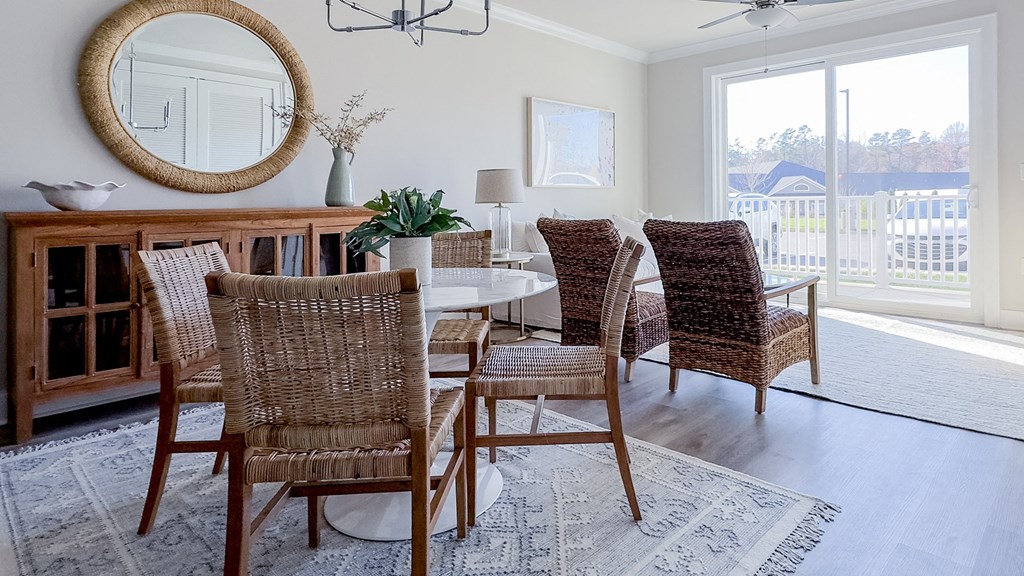 a dining room with a table and chairs and a window