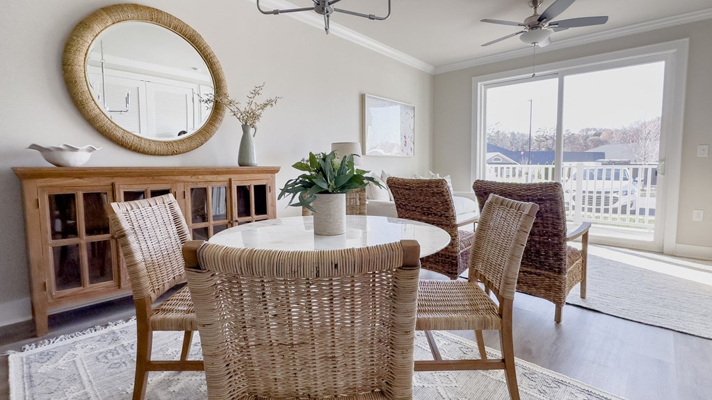 a dining room with a table and chairs and a window
