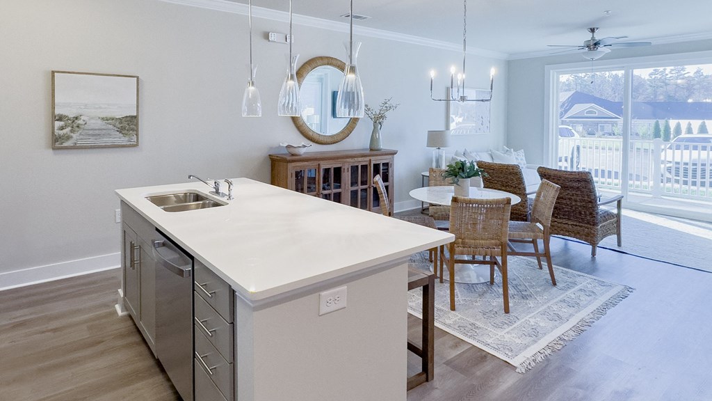 a kitchen and dining room with a sliding glass door to a balcony