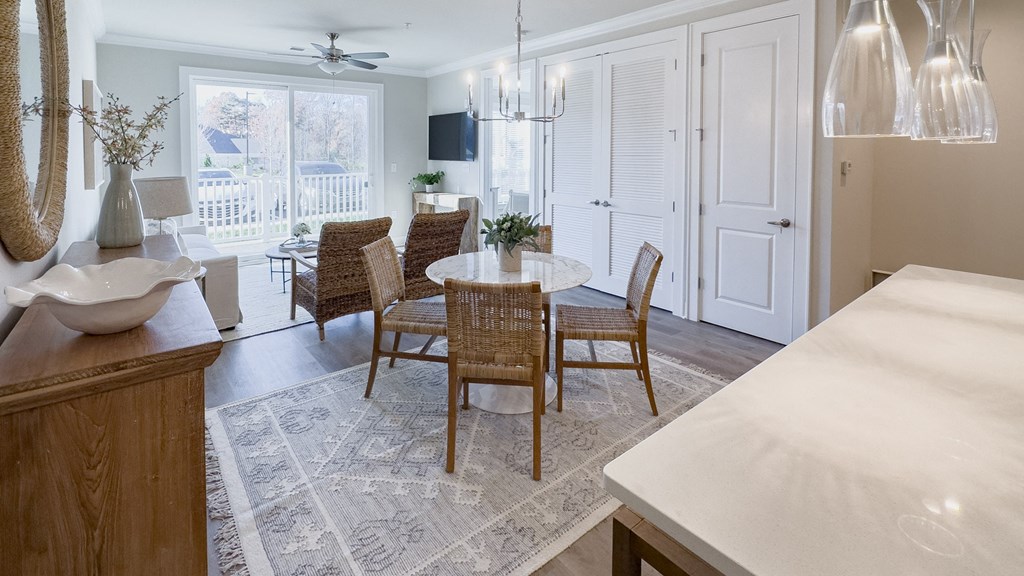 a kitchen with a dining room with a table and chairs