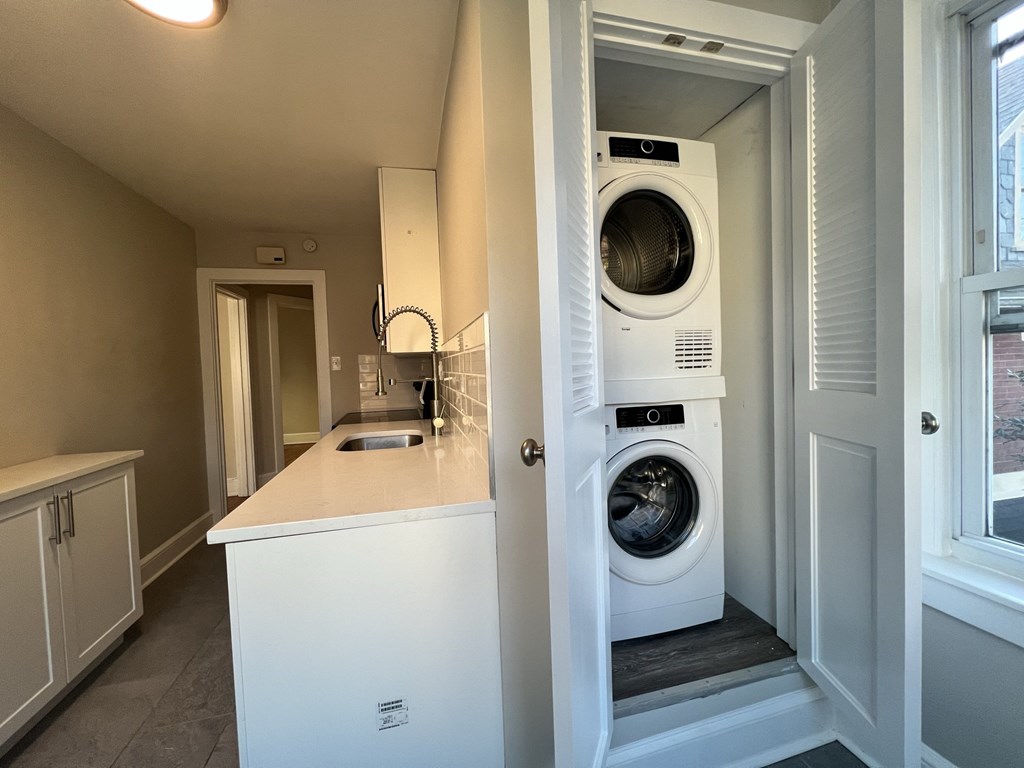 a laundry room with a washing machine and a washer and dryer