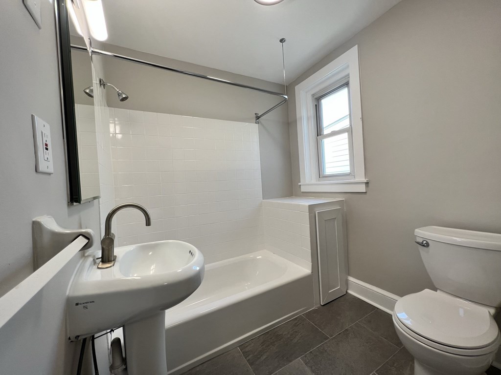 an empty bathroom with a sink toilet and bath tub