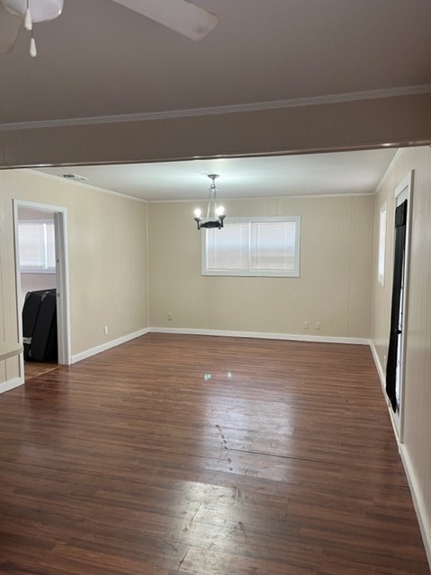 an empty living room with a hard wood floor