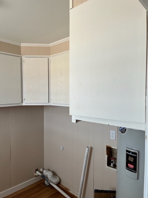 a kitchen with a stove and white cabinets