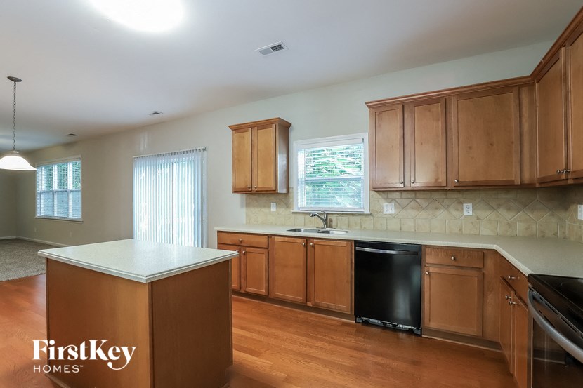 a kitchen with wooden cabinets and a white counter top