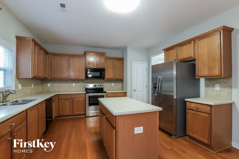 a kitchen with wooden cabinets and stainless steel appliances