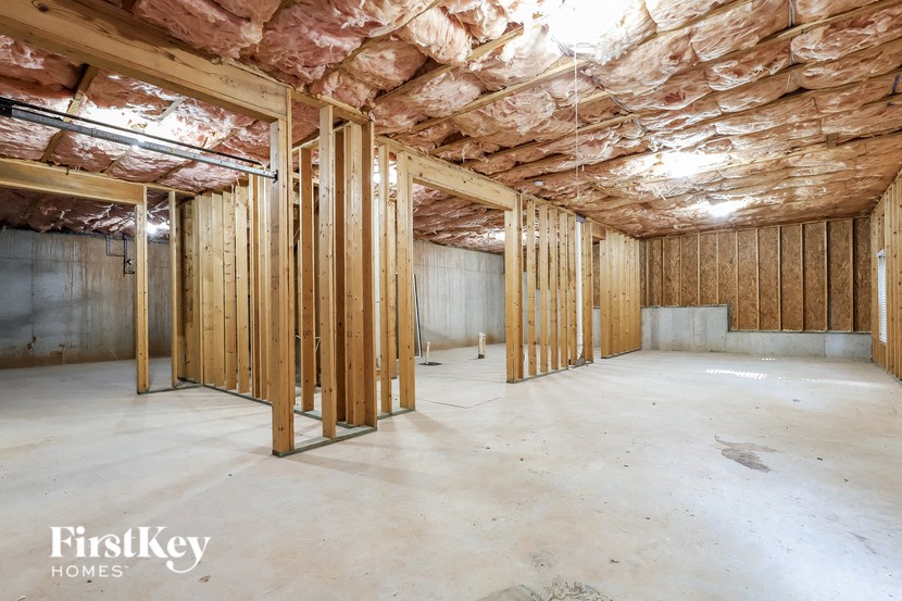 a large unfinished basement with wood framing and exposed ceilings