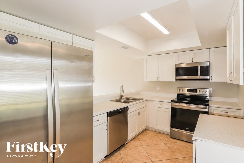 a kitchen with stainless steel appliances and white cabinets